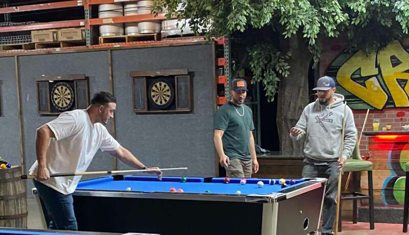 Customers playing pool at Bay Boys Brewing, enjoying a fun game with cold drinks.